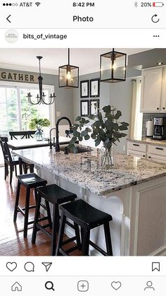 a kitchen island with stools in front of it