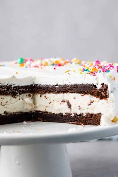 a chocolate cake with white frosting and sprinkles