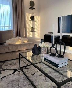 a living room filled with furniture and a flat screen tv on top of a table