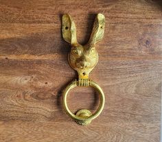 a golden door handle with a rabbit head on it