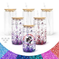 six glass jars filled with confetti and sprinkles on a white background