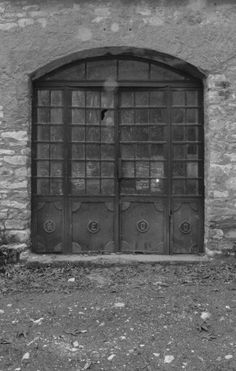 an old brick building with two large doors