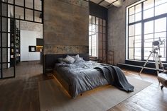 an empty bedroom with large windows and wooden flooring is pictured in this modern apartment