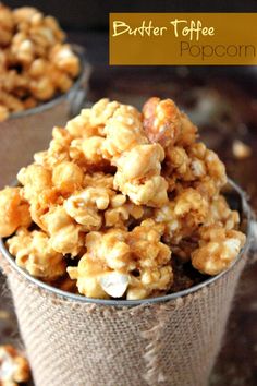 two cups filled with caramel popcorn on top of a table