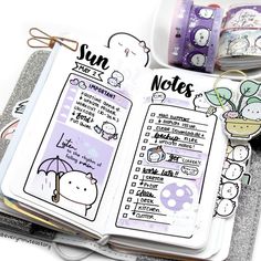 an open planner book with stickers on it and some other items around the page