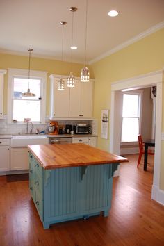 a kitchen with an island in the middle of it