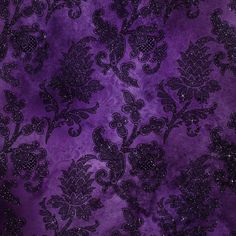 a purple and black fabric with floral designs on the top, it is very dark