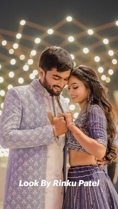 a man and woman standing next to each other on a dance floor with lights in the background