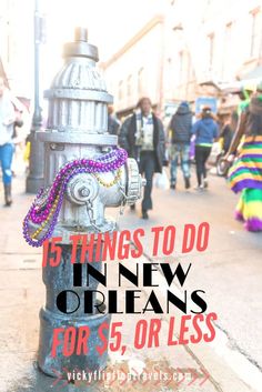 a silver fire hydrant with beads on it and people walking down the street in the background