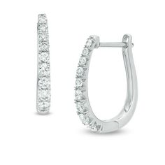 Take your dressy looks to the next level with these dazzling certified diamond hoop earrings. Created in 14K white gold, each 17.0 x 12.0mm oval-shaped hoop features a row of sparkling graduated-size diamonds - the largest being 1/20 ct. stones. Each diamond boasts a color rank of H and a clarity of I1. Radiant with 1/2 ct. t.w. of diamonds and a bright polished shine, these earrings secure with hinged backs. This style arrives with a certificate that includes a photo and description of the diam