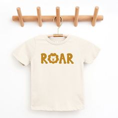 Looking for a cute tee for your kids? We have the perfect Roar Lion graphic tee addition to their closet! Also available in youth tees. Lion Graphic, Trending Graphic Tees, Roaring Lion, Star Wars Light Saber, Kids Graphic Tees, Top Graphic Tees, Kids Outfits Girls, Toddler Tees, Toddler Girl Outfits