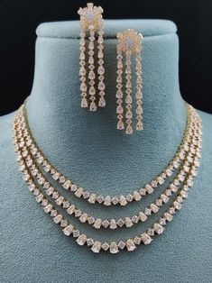 Experience the fusion of American innovation and Indian artisanship in our latest creation. Designed in the USA and meticulously handcrafted in India, this necklace set boasts american diamonds. Its design ensures effortless pairing with any ensemble, adding a touch of versatility to your jewelry collection. A symbol of boundless creativity and cross-cultural love, it's more than just a necklace – it's a statement of modern elegance. Handcrafted Metal: Metal Alloy, Gold Plated Necklace Set inclu Long Jewellery Necklace, Luxury Temple Necklace With Elegant Design For Wedding, Luxury Dual-tone Temple Jewelry Necklaces, Diamond Necklace Set Indian, Modern Indian Jewelry, American Diamond Necklace Set, Trending Jewellery, Unique Locket, Bridal Necklace Designs