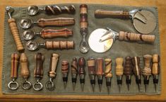 an assortment of kitchen utensils and spoons laid out on a table