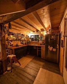 a kitchen with wood floors and wooden walls