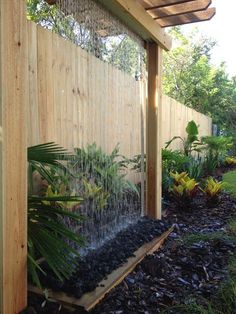 a wooden fence with plants growing on it