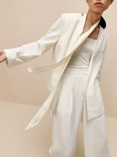 Featured in our recent runway show, the Collarless Blazer from our 2022 Spring & Summer Collection merges the flow of rich mulberry silk and breathable linen for an elevated formal piece you'll want for any outdoor event this summer. Details Materials & Care Shipping & Returns • Tailored in a relaxed, oversized flowing cut — perfect for the summer heat.• Cut from a lightweight and luxurious blend of mulberry silk and linen: the perfect drape and excellent breathability.• Pair with your favorite White Silk Blazer For Workwear, White Silk Blazer For Work, Summer Formal Cream Blazer, Summer Cream Formal Blazer, Elegant Linen Blazer For Office, Modern Linen Blazer, Luxury White Linen Blazer, Elegant Cream Summer Blazer, White Mulberry