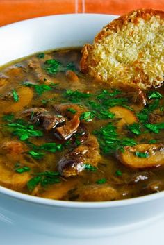 a white bowl filled with meat and vegetable soup