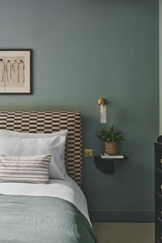 a bedroom with green walls and white bedding, two nightstands on either side