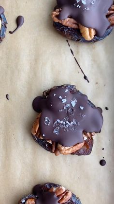 three cookies with chocolate drizzled on them