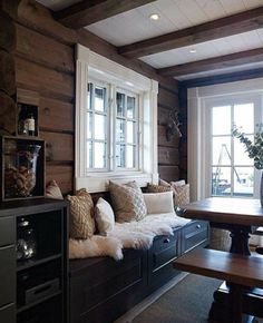 a living room filled with furniture and wooden walls