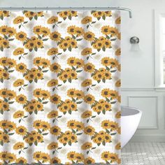 a shower curtain with sunflowers on it in a white and yellow bathroom setting