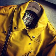 a yellow leather jacket with a hat on it