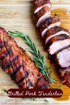 grilled pork tenderies on a cutting board with rosemary sprigs