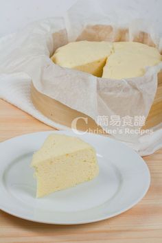 a piece of cake sitting on top of a white plate next to a wooden tray