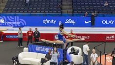 a woman is performing on the balance beam