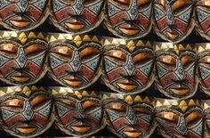 many decorative masks are arranged in rows