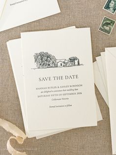 the wedding stationery is laid out with stamps and envelopes