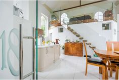 an open kitchen and dining area with stairs