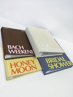 four books are stacked on top of each other with the covers pulled back to reveal their names