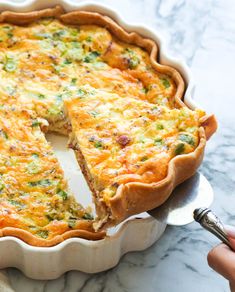 a quiche pie with one slice missing from it