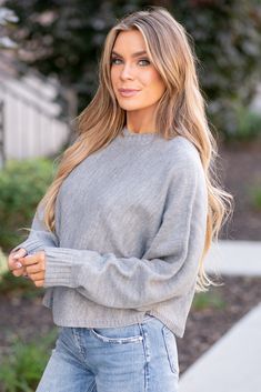 This cropped sweater features a round neck and dolman sleeves for a relaxed and stylish look. The cropped length adds a modern and trendy touch to the design. The dolman sleeves provide a comfortable and loose fit, perfect for effortless chic styling. With its versatile round neck, this sweater can be easily paired with different bottoms for various outfits. The cozy knit fabric makes it a great piece for staying warm and fashionable in cooler weather. Overall, this round neck dolman sleeve crop Trendy Long Sleeve Cropped Sweater With Soft Texture, Trendy Cropped Sweater With Soft Texture, Chic Cropped Crew Neck Sweater, Trendy Crew Neck Cropped Sweater In Soft Knit, Trendy Cropped Sweater With Crew Neck In Soft Knit, Trendy Cropped Soft Knit Sweater With Crew Neck, Trendy Crew Neck Cropped Sweater, Trendy Fall Cropped Sweater For Everyday, Chic Cropped Crew Neck Sweater For Layering