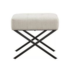 a white ottoman with black metal legs and a beige upholstered foot rester