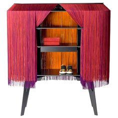 a pink and orange cabinet with some shoes on it