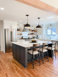 a large kitchen with an island in the middle