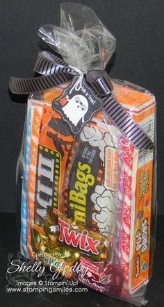 an orange and white candy wrapper wrapped in clear cellophane with a black ribbon