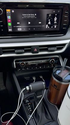 an image of a car stereo with coffee and mp3 player in the dash board area