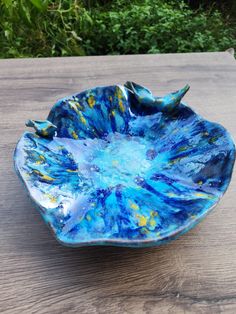 a blue bowl sitting on top of a wooden table