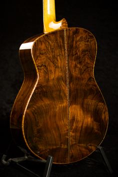 an acoustic guitar sitting on top of a stand