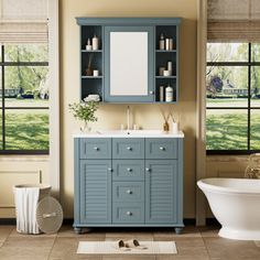 a bathroom with a sink, mirror and bathtub next to two windows that have blinds on them