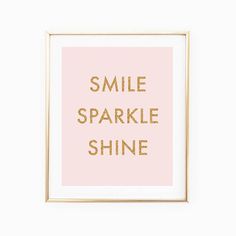 a pink and gold framed print with the words smile sparkle shine in gold foil on it