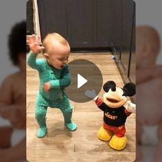 the baby is playing with mickey mouse