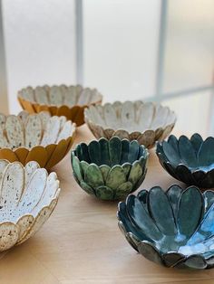 several bowls are sitting on a table together