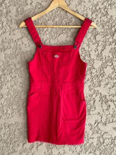 "Brand new tag still attached red jean Dickies overall dress. Women's Size XS 97% Cotton 3% Spandex. The material has a tiny bit of stretch to it.  The dress has 6 pockets. adjustable overall straps, and a zipper going down the back for easy slip-in. Super cute! Measurements laying flat Armpit to armpit 14.5\" (29\" total) Across the waist 13\" (26\" total) Total length of the dress is 32\" at its longest the straps are adjustable so its 27\" at its shortest. Items are shipped out within 1-2 bus Red Denim Dress, Fitted Red Overalls, Casual Red Cotton Shortalls, Fitted Cotton Casual Pinafore Dress, Casual Fitted Knee-length Pinafore Dress, Fitted Cotton Pinafore Dress Casual Style, Fitted Sleeveless Pinafore Dress With Pockets, Fitted Cotton Knee-length Pinafore Dress, Casual Knee-length Fitted Pinafore Dress