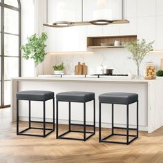 three stools sit in front of a kitchen island