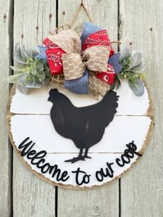 a welcome to our coop sign hanging on the side of a wooden fence with a bow