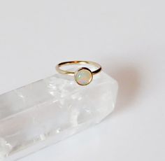 This Ethiopian opal gold filled nose ring is handmade by me using gold filled wire (gold filled wire is different than gold plated in that the plating is much thicker making it higher quality. It will never peel off the way gold plated jewelry does. with proper care it can last as long as real gold.) . A 3mm gold filled setting is soldered onto the ring with a small Ethiopian opal stone set inside of it. You can choose your gauge and diameter at checkout.   *NOTE* To open ring twist to the side Helix Ring, Small Nose, Cartilage Ring, Nose Hoop, Nose Ring Stud, Open Ring, Stone Settings, Gold Plated Jewelry, Ethiopian Opal